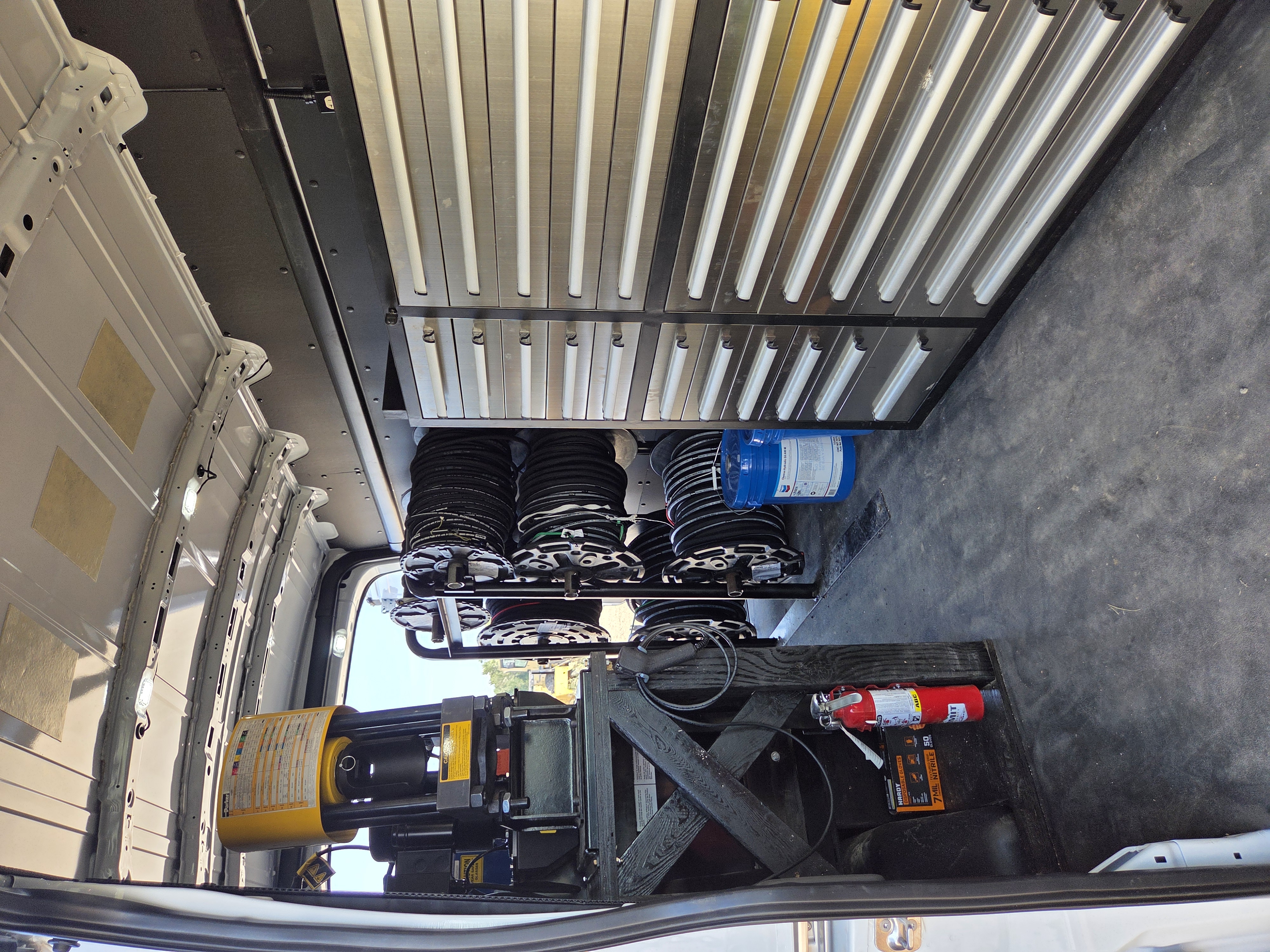 Hydraulic hose reel wall inside the service van